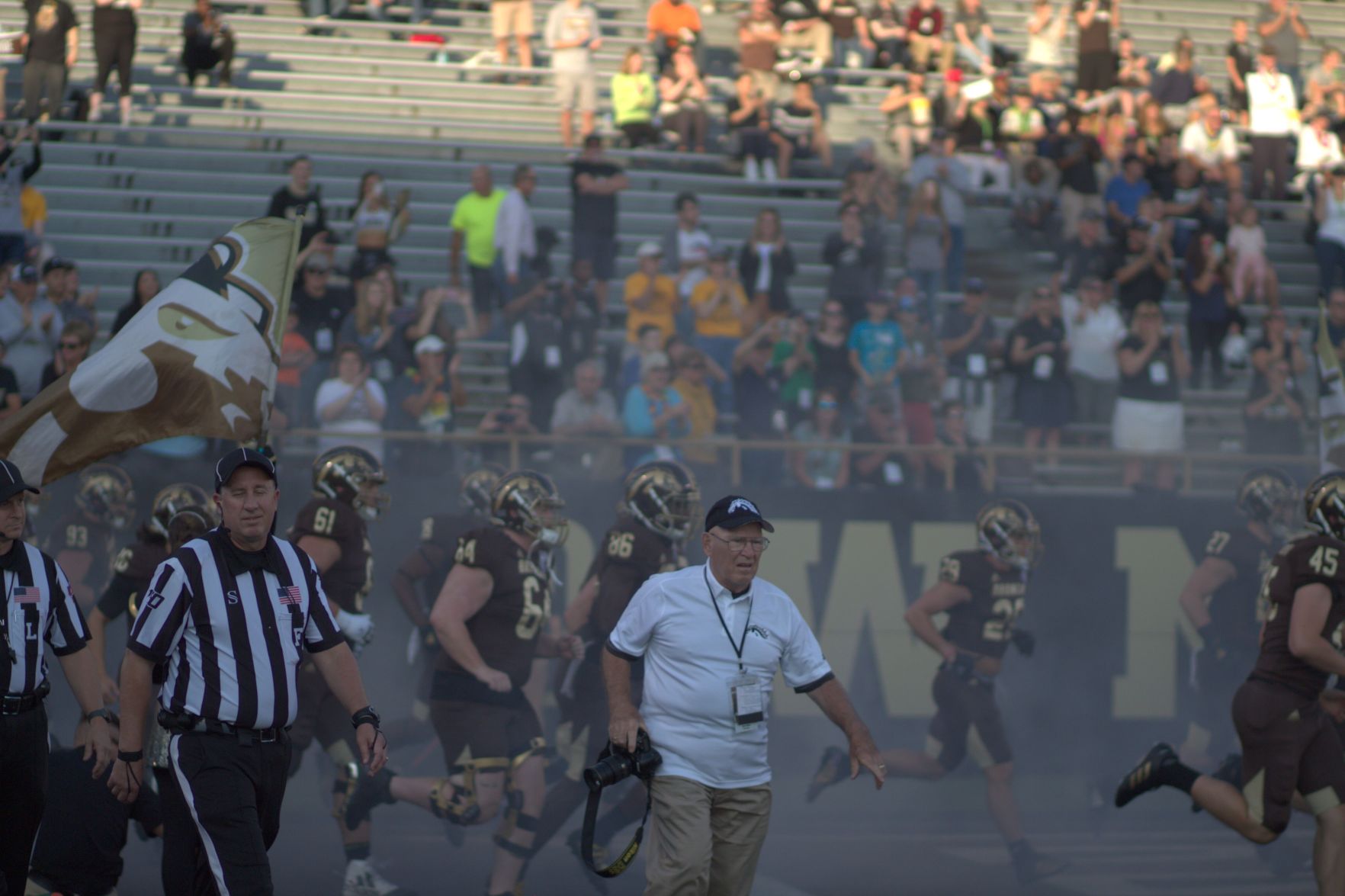 WMU Athletics photographer Gary Shook runs out of the tunnel as the Broncos take the field.